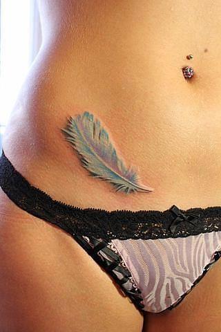 a piece of  feather tattoo