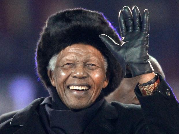 South Africa's former President Nelson Mandela waving as he arrives to attend the 2010 World Cup football final Netherlands vs. Spain at Soccer City stadium in Soweto, near Johannesburg.
