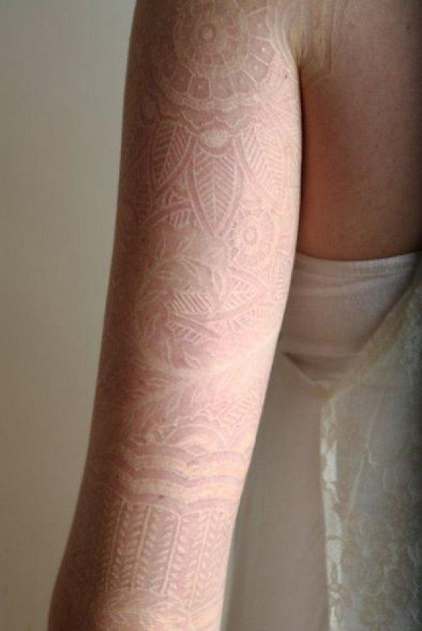 36 White ink lace tattoo on arm