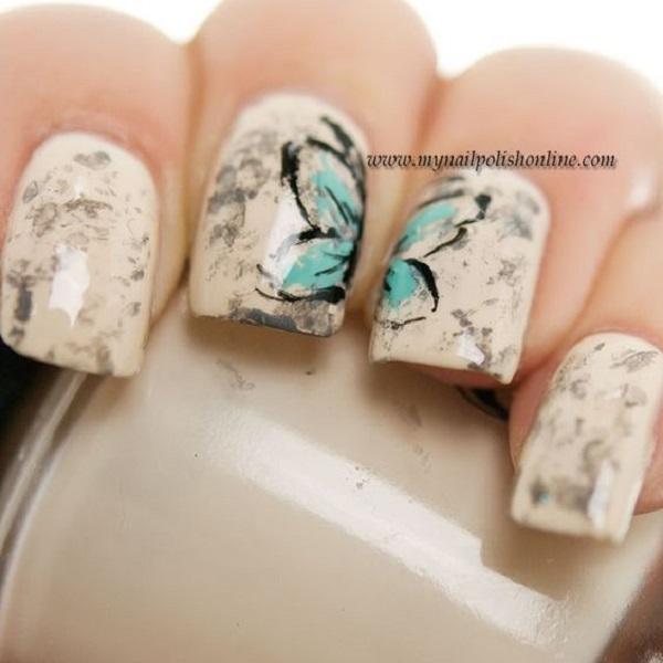 Beautiful marble inspired butterfly nail art. The base of the nails is coated in cream and gray colors depicting a marble like design, as a ...