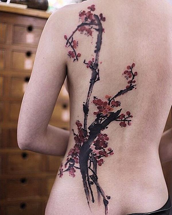 Enchanting cherry blossom tattoo on the back. Brush stroke inspired, the simple strokes that make up the branches of the cherry blossom adds...