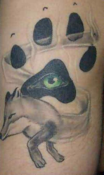 Dog Paw Print Tattoo with an eye peaking through as a fox escapes.
