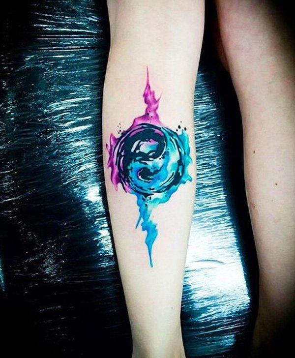 An orb like Yin Yang tattoo. The symbol is enveloped in an orb like structure with plasma effects floating around it.