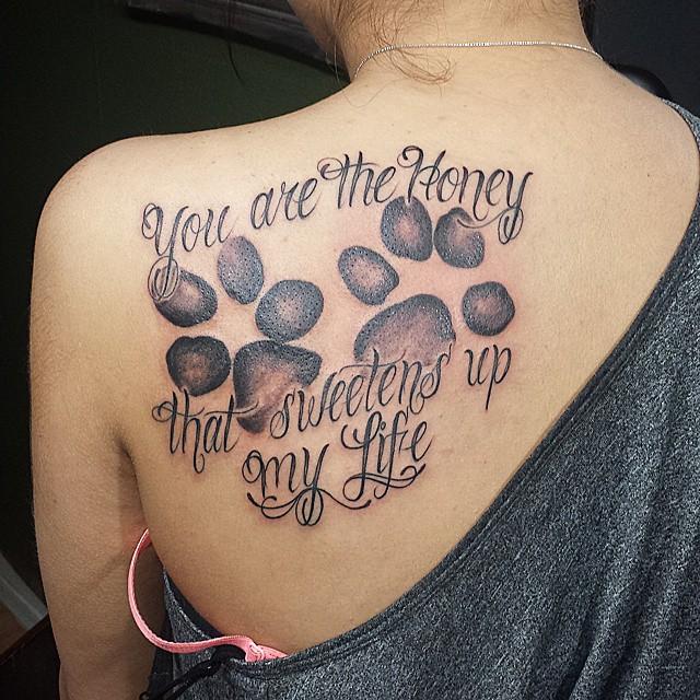 paw print tattoos on back with quotes