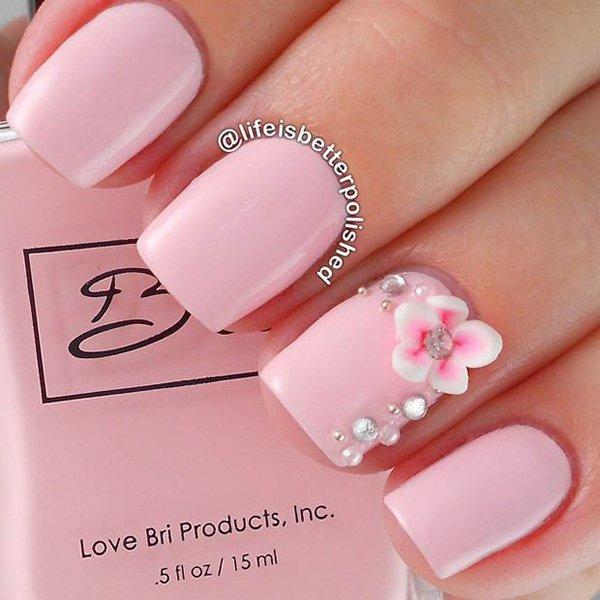 A very classy looking and elegant baby pink nail art design. The matte baby pink color looks great with the additional bed and flower accent...