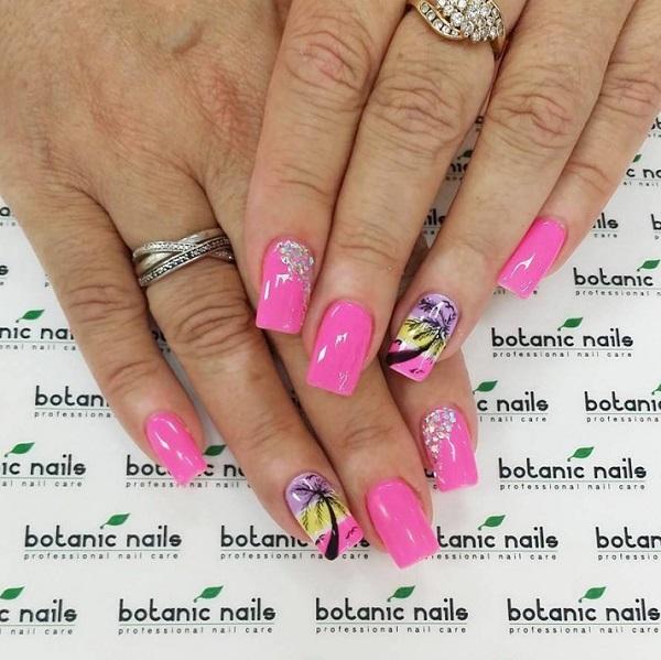 Hot pink Palm Tree Nail Art design. The silhouette of a palm tree is painted as it is framed by an afternoon pink sky. The rest of the nails...