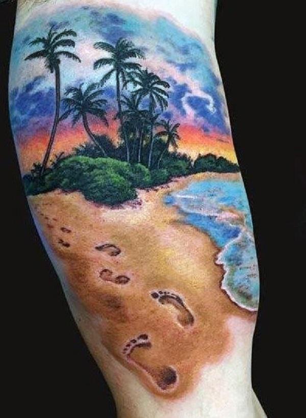 Beach tattoo in bold colors. The bright and bold ink used in the tattoo makes the design pop out of the skin. The footsteps in the sand also...