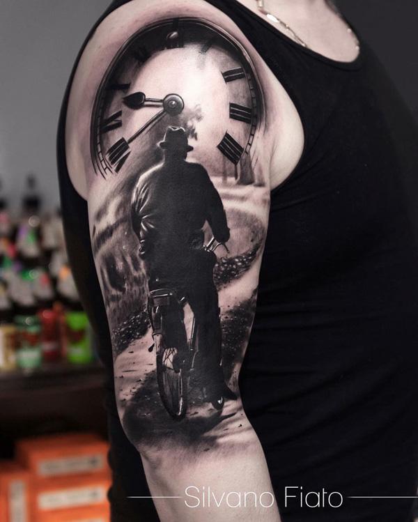 Beautiful sleeve tattoo of a man riding his bike. The attention to detail that this tattoo has as well as the amazing lighting makes it trul...