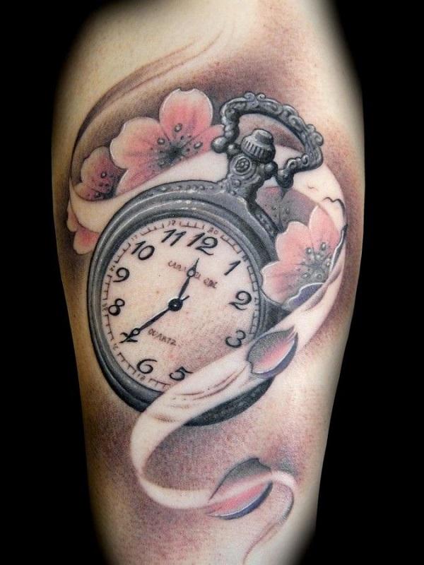 Cherry blossom tattoo with a pocket watch. The pretty cherry blossoms are seen to be enveloping a silver pocket watch emphasizing on the mea...