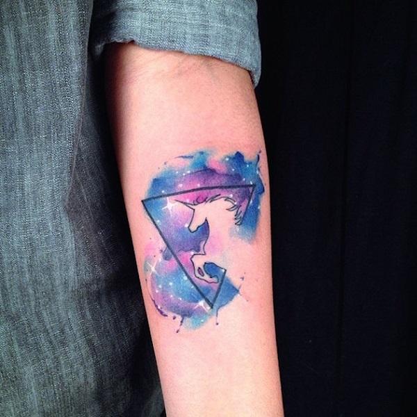 A silhouette of a unicorn tattoo. Designed in abstract style, you can make out the shape of the unicorn jumping into the triangle shape and ...