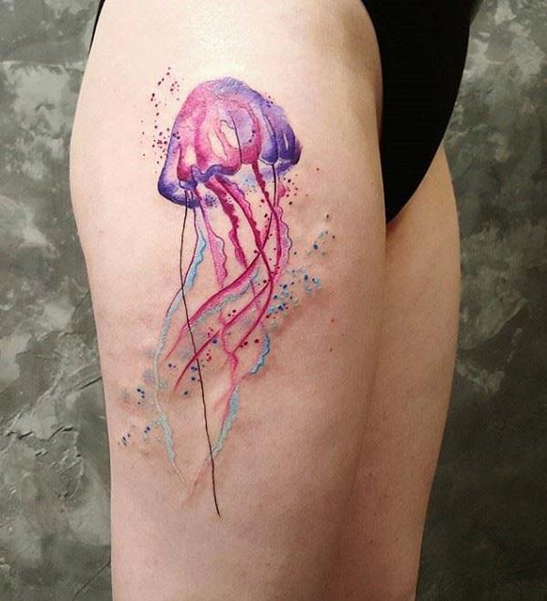 Beautiful jellyfish tattoo on the thigh. The colors are very pretty and complement each other. You can see how serene the jellyfish looks as...
