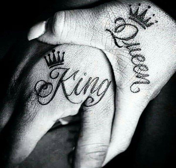 Another royalty inspired couple tattoo. Instead of crowns the king and queen words are directly written on the hands with just a simple outl...