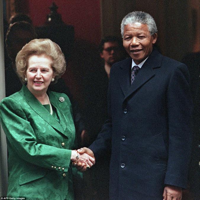 South African anti-apartheid leader and African National Congress (ANC) member Nelson Mandela (R) shaking hands with British Prime Minister ...