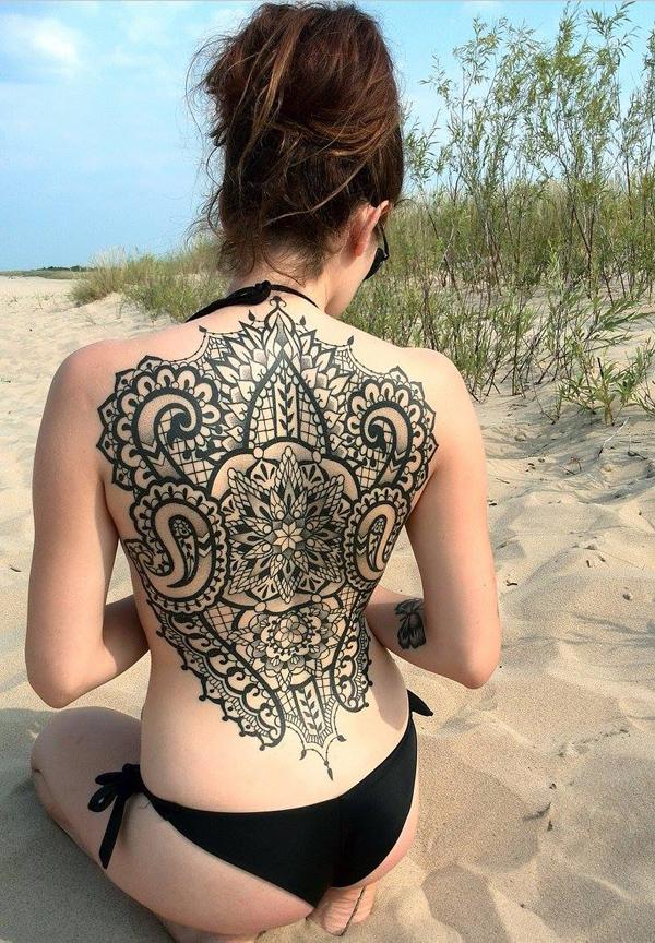 Mandala back tattoo for women - Crown shaped mandala tattoo in black. The best place for the mandala tattoo is on the back because of the fl...