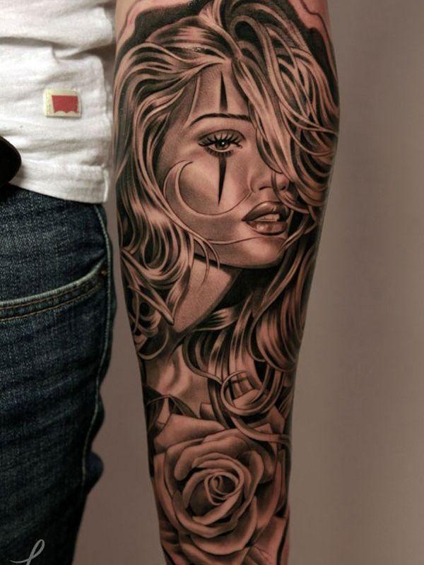 Woman portrait tattoo on the left thigh.
