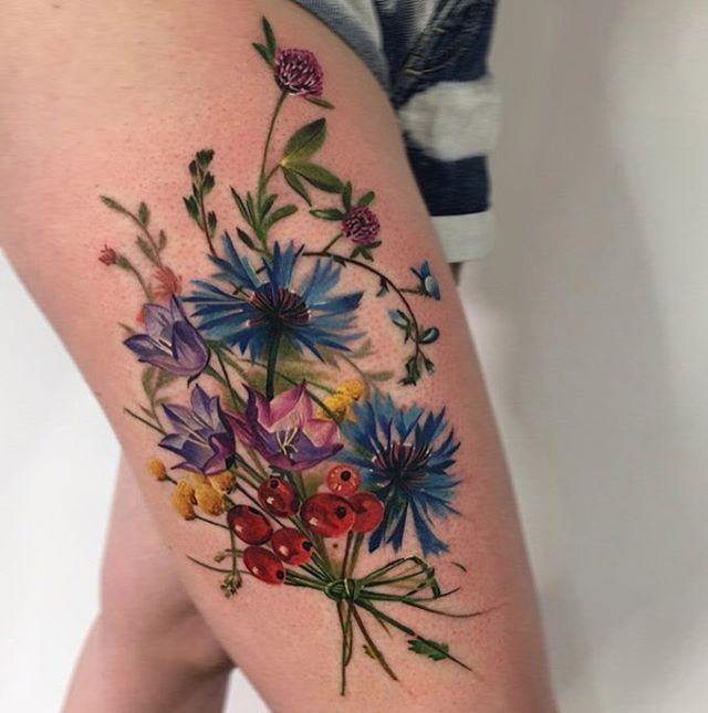 Flower thigh tattoo