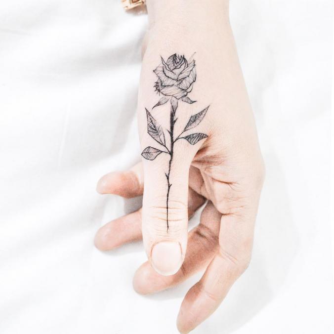Rose finger tattoo