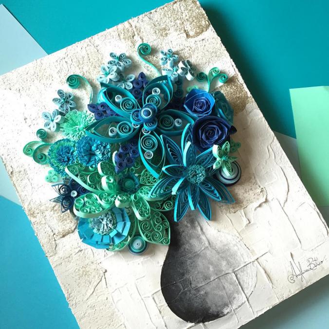 Quilled paper flowers on wooden canvas