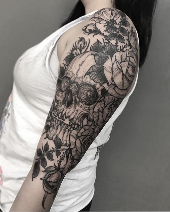 Skull and flower sleeve tattoo
