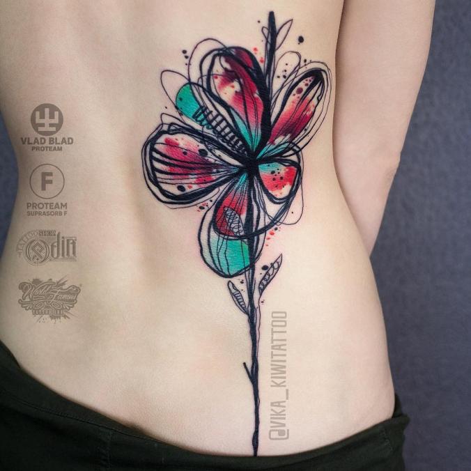 Watercolor flower back tattoo