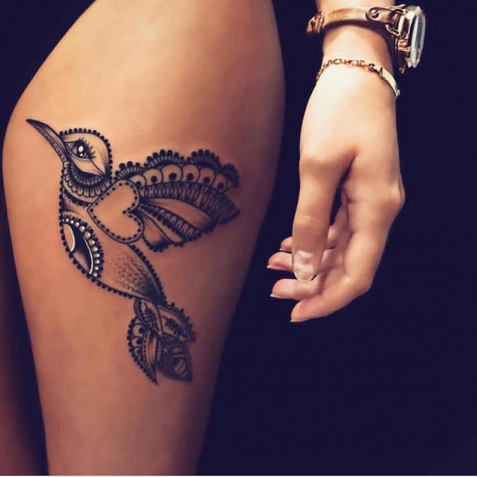 Mandala bird tattoo on thigh