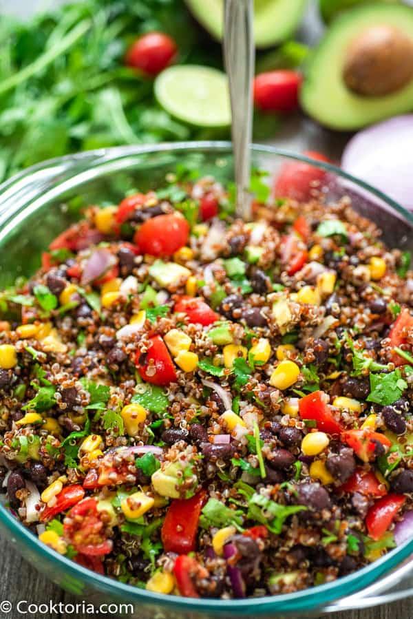 Tex Mex Quinoa Salad in a large bowl with vegetables on a background