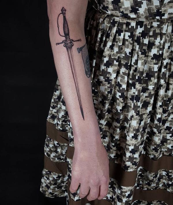 sword tattoo on the forearm of girl