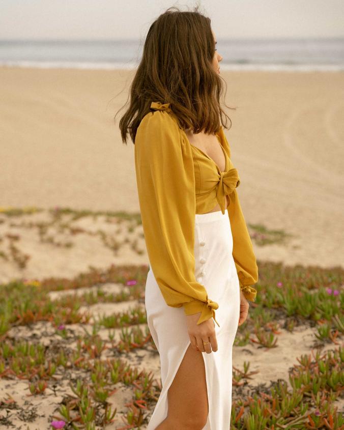 Click to shop outfit + more photos! Sarah Butler of Sarah Styles Seattle wears Yellow bell sleeve crop top and side slit silk midi skirt in ...