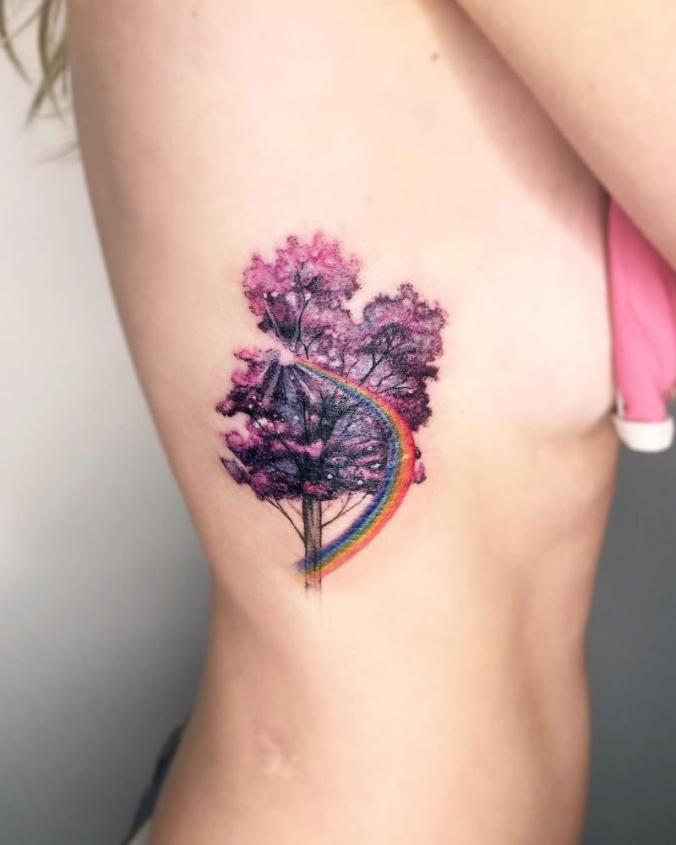 Purple watercolor tree tattoo on rib