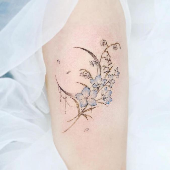 moon with blue flowers tattoo